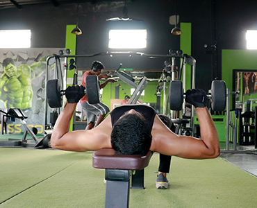 Dumbbell bench press exercises in fitness zone