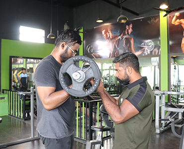 Barbell curl exercise with mentor